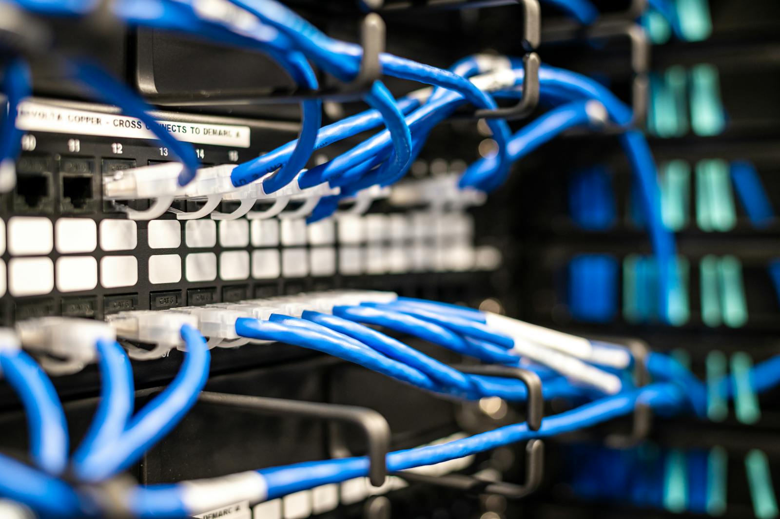 Blauwe netwerkkabels in serverrack symboliseren DNS records en domeinverkeer
